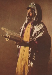 A Yemenite Jew at morning prayers, wearing a kippah skullcap, prayer shawl and tefillin