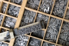 Movable metal type, and composing stick, descended from Gutenberg's press
